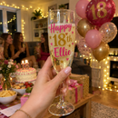 Flute printed Happy 18th Ellie raised at a party with fairy lights