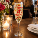 Red and gold Happy 21st Chloe flute on a restaurant table