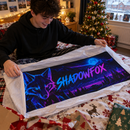 Neon gamer tag desk mat being unwrapped on Christmas morning