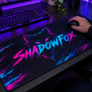 Close-up of a hand on a mouse over a neon gamer tag mat