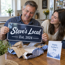 Dad unwrapping a Father's Day gift: metal sign printed 'Steve's Local, Est. 2024'