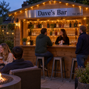 Home shed bar with a long metal sign reading 'Dave's Bar, Est. 2021' above the counter