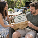 Partner unwrapping a metal beer garden rules sign reading 'The Garden Arms Rules' on a patio