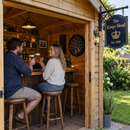 Summerhouse home bar with a navy hanging pub sign reading 'The Kings Head, Est. 2018'
