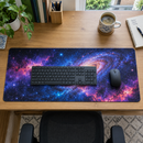 Top-down view of a nebula desk mat with keyboard, notebook and coffee