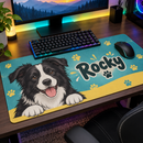 Cartoon border collie mat under a keyboard and mouse on an RGB gaming desk