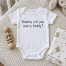 Lifestyle photo of the Mummy marry Daddy proposal baby grow in a UK home