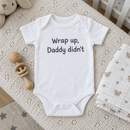 Lifestyle photo of the wrap up Daddy didn't funny baby grow in a UK home
