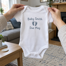 Lifestyle photo of the baby due announcement baby grow with feet in a UK home