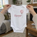 Lifestyle photo of the baby name balloon baby grow in a UK home