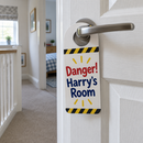 Personalised danger door hanger keep-out sign on a kids bedroom door