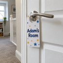 Personalised bedroom door hanger with a name hanging on a bedroom door handle
