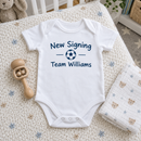 Lifestyle photo of the new signing baby grow with surname in a UK home