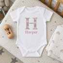 Lifestyle photo of the initial and name baby grow in a UK home