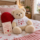 Personalised Valentine's teddy bear with a printed t-shirt sitting on a bed