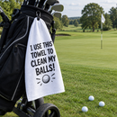 Rude golf towel hanging from a golf bag on a UK golf course