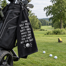 Cheeky golf towel hanging from a golf bag next to a tee box