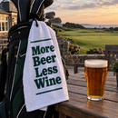 Funny beer golf towel on a golf bag outside the clubhouse with a pint