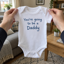 Lifestyle photo of the You're Going To Be A Daddy baby grow in a UK home