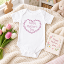 Personalised Mother's Day baby grow lifestyle photo with Heart Wheel design in pink, printed with baby's name