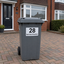 Personalised wheelie bin sticker with house number on a grey bin outside a UK home