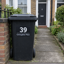 Personalised wheelie bin sticker on a black bin by a terraced house