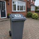 Personalised wheelie bin sticker with a large house number on a bin lid