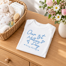 Personalised first Mother's Day baby grow lifestyle photo with Our 1st Mother's Day design in blue, printed with baby's name