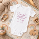 Personalised first Mother's Day baby grow lifestyle photo with Our 1st Mother's Day design in pink, printed with baby's name