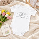 Personalised Mother's Day baby grow lifestyle photo with Hand Heart design in black, printed with baby's name