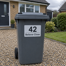 Personalised wheelie bin sticker on a grey bin outside a detached house