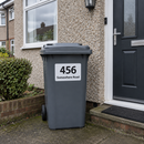 Personalised wheelie bin sticker on a grey bin beside a front door