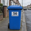 Personalised wheelie bin sticker on a blue recycling bin on a terraced street