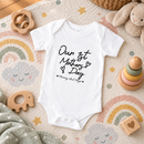 Personalised first Mother's Day baby grow lifestyle photo with Our 1st Mother's Day design in black, printed with baby's name
