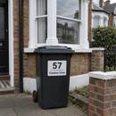 Personalised wheelie bin sticker on a black bin by a terraced house