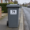 Personalised wheelie bin sticker on a grey bin at the kerb