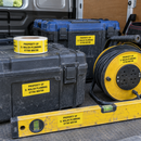 Tool cases in a van marked with yellow equipment ID labels