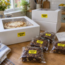 Cake boxes and brownies sealed with yellow Contains Nuts stickers