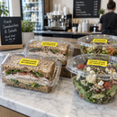 Cafe sandwich boxes with yellow sesame allergen stickers on the lids