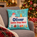 Turquoise Christmas cushion on a sofa beside the Christmas tree