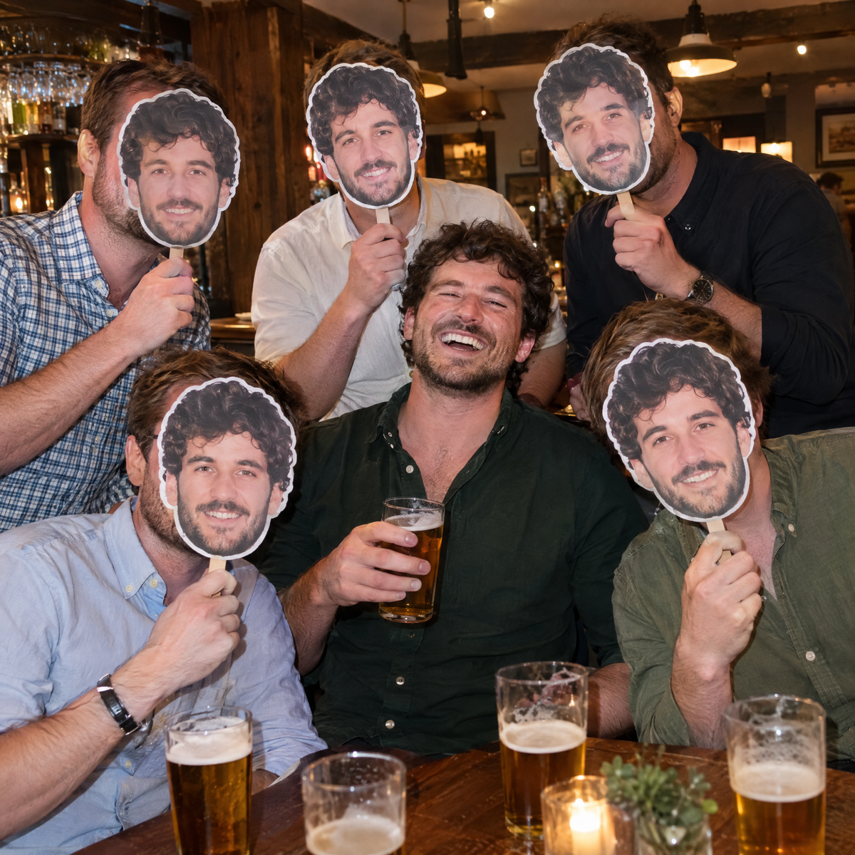 Stag group in a pub holding stag do face masks of the laughing groom