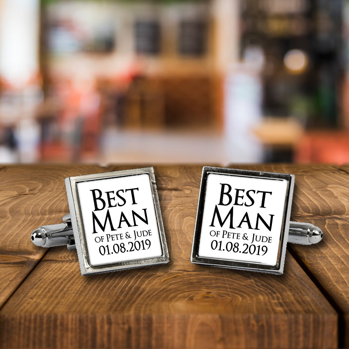 Personalised Best Man Cufflinks with Couple's Names & Date – Wedding Gift for Him – White or Black Print, Chrome or Rose Gold – Personalised Best Man cufflinks, a chrome square pair with white print on a wooden bar table