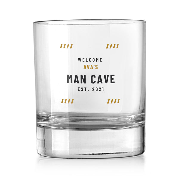 Personalised man cave whisky tumbler with a gold and charcoal Welcome, name and Man Cave design, UV DTF printed on a clear whisky tumbler