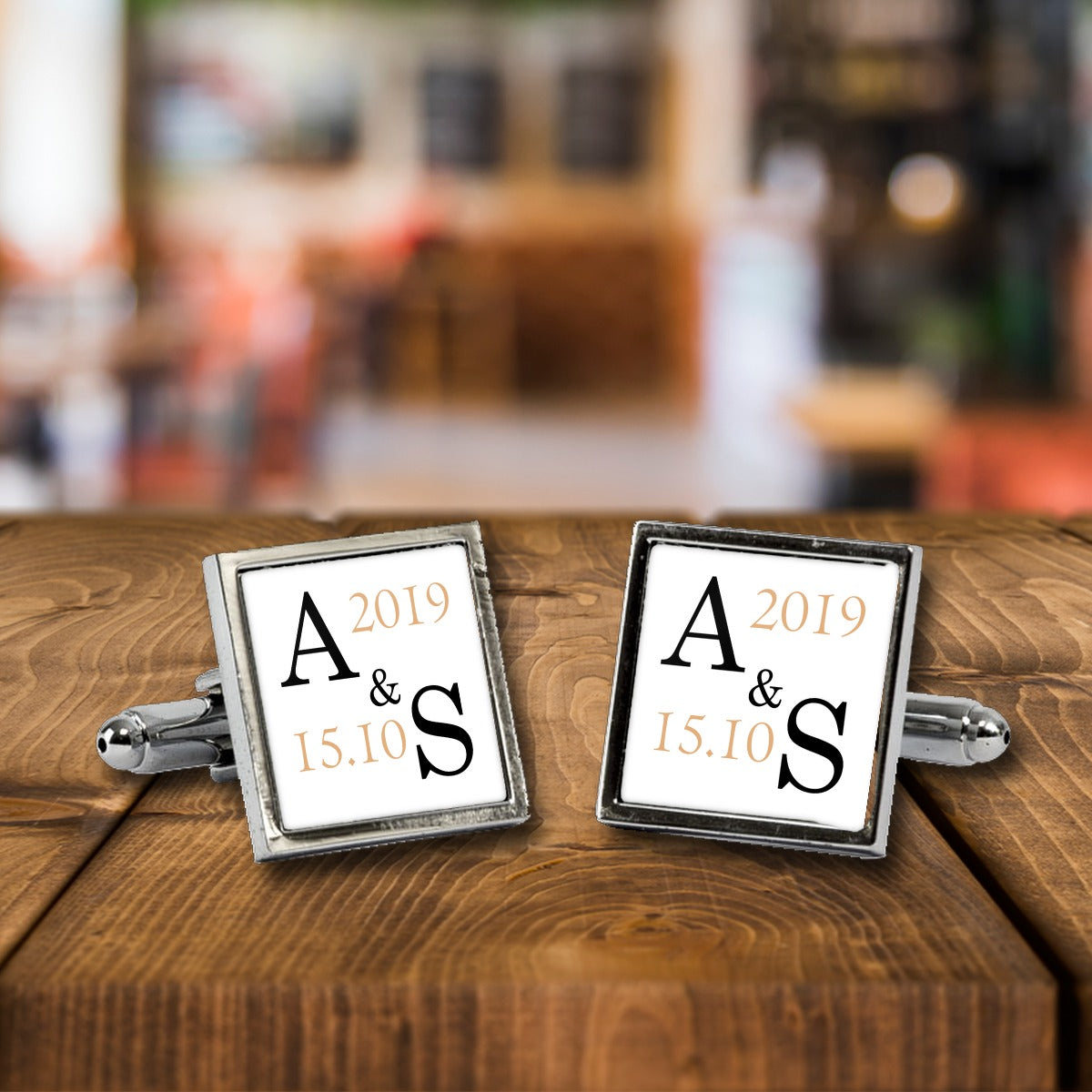Personalised Wedding Initials Monogram Cufflinks with Date – Wedding Gift for Him – White or Black Print, Chrome or Rose Gold – Personalised Wedding Initials Monogram cufflinks, a chrome square pair with white print on a wooden bar table