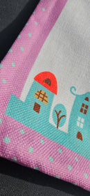 Linen-look woven fabric and snowy village border on the pink cover