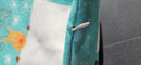 Concealed zip on the edge of the turquoise cushion cover