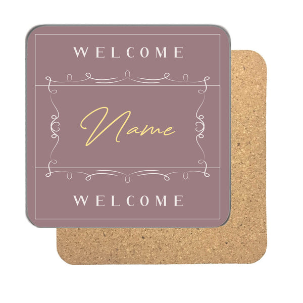 Personalised welcome name coaster in blush pink with a name in gold script between two Welcome lines